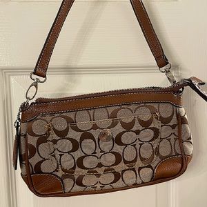 Brown Coach handbag with leather piping and outside pockets. Never used.